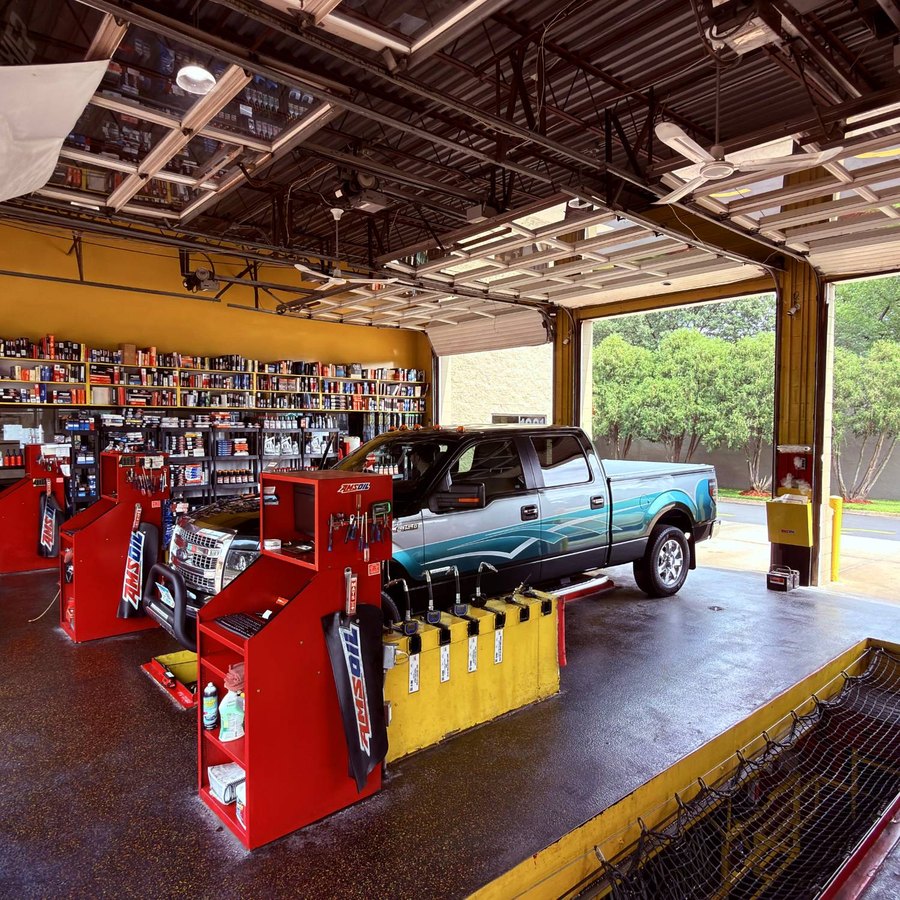 Inside a service bay: a truck on the floor, tool chests and the parts wall